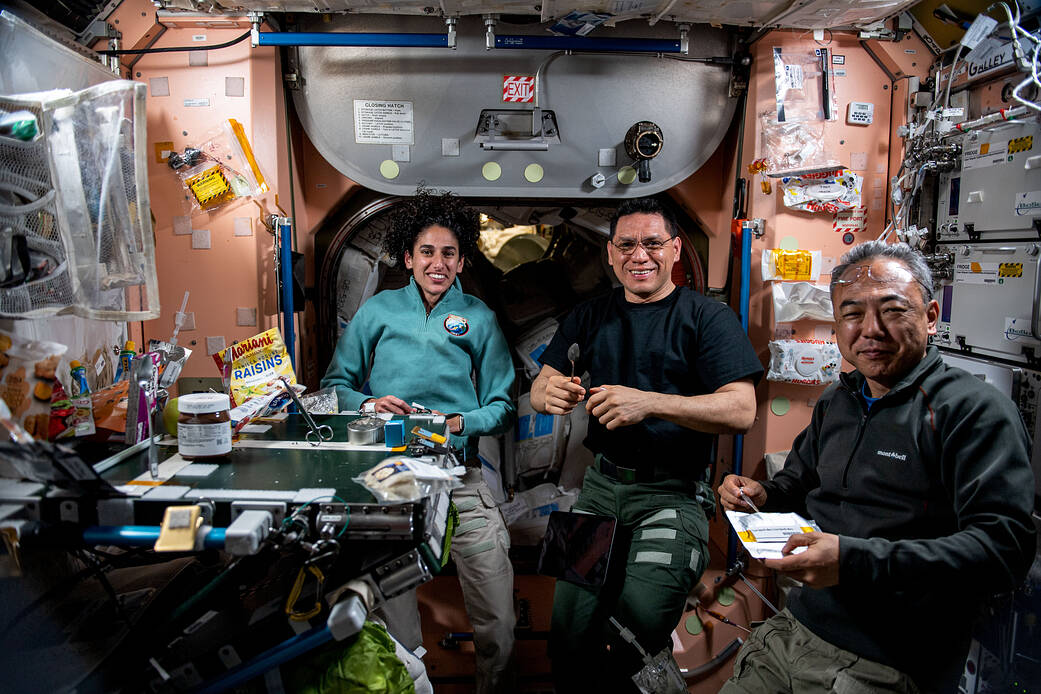 Expedition 69 flight engineers join each other for lunch