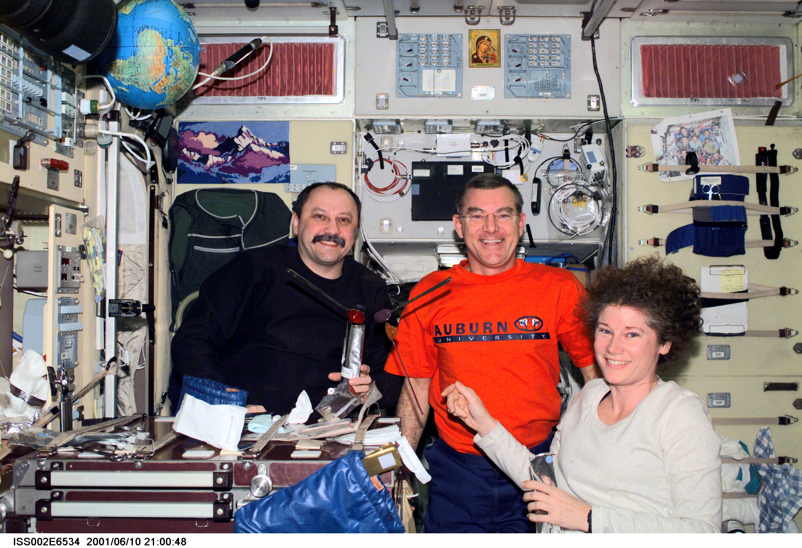 Expedition Two crewmembers Yury V. Usachev (left), mission commander, James S. Voss, flight engineer, and Susan J. Helms, flight engineer, share a ...
